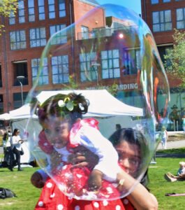 WM2 a mum holding her baby up for the bubbles_Paul King